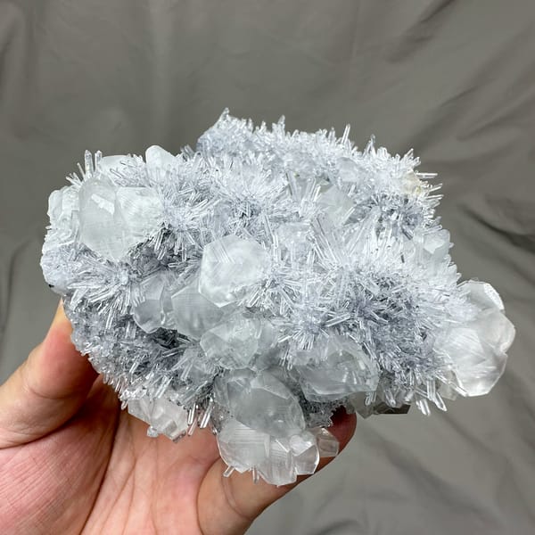 Frosted quartz needles around pale calcite prisms from Fujian, China, top view