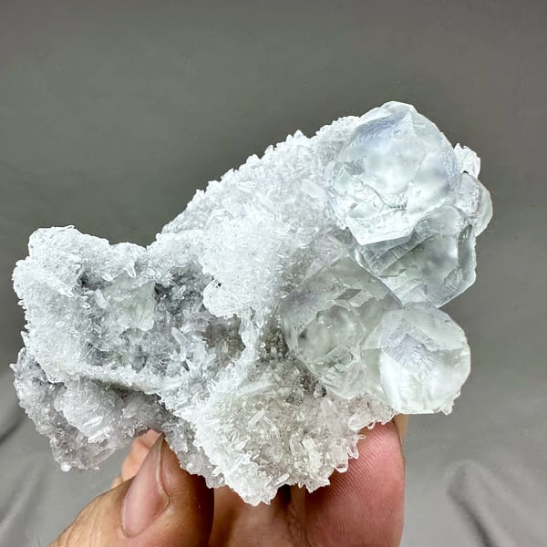 Pale blue-cored fluorite cubes on frosted white quartz from Fujian, China, close-up of the crystal faces