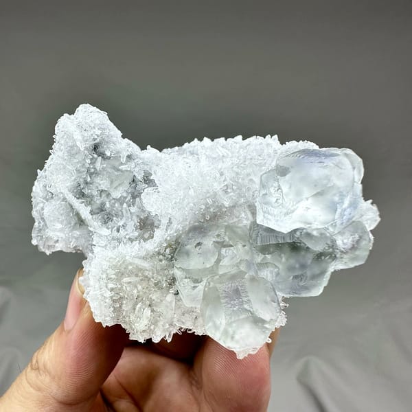 Pale blue-cored fluorite cubes on frosted white quartz from Fujian, China, reverse side