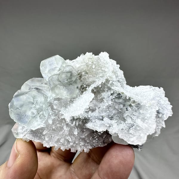 Pale blue-cored fluorite cubes on frosted white quartz from Fujian, China, detail of the matrix contact