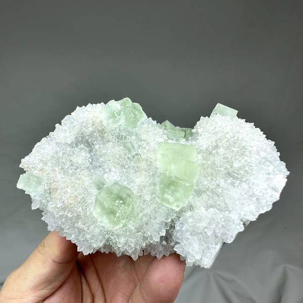 Transparent pale-green fluorite cubes on frosted white quartz from Guangdong, China, top view
