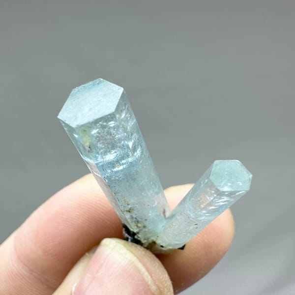Two sky-blue aquamarine prisms with black tourmaline from Namibia, second angle