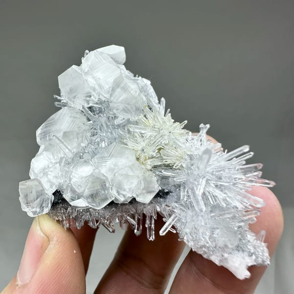 Clear quartz needles with white calcite prisms and pyrite from Fujian, China, close-up of the crystal faces