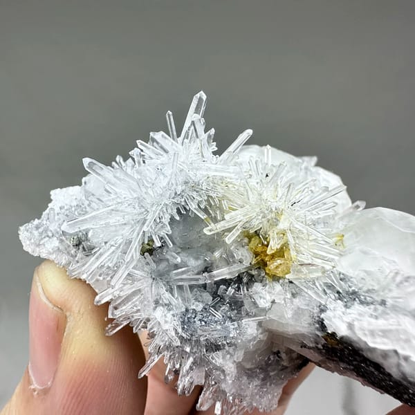 Clear quartz needles with white calcite prisms and pyrite from Fujian, China, top view