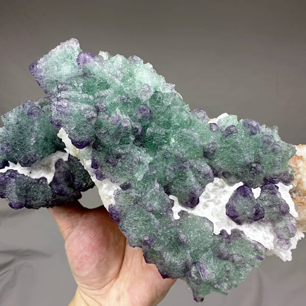 Purple and green stepped octahedral fluorite over white quartz from Zhejiang, China, second angle