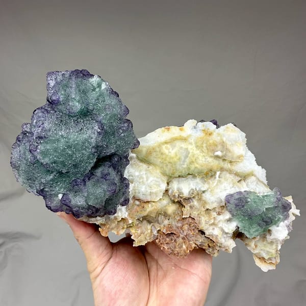Purple and green stepped octahedral fluorite over white quartz from Zhejiang, China, top view
