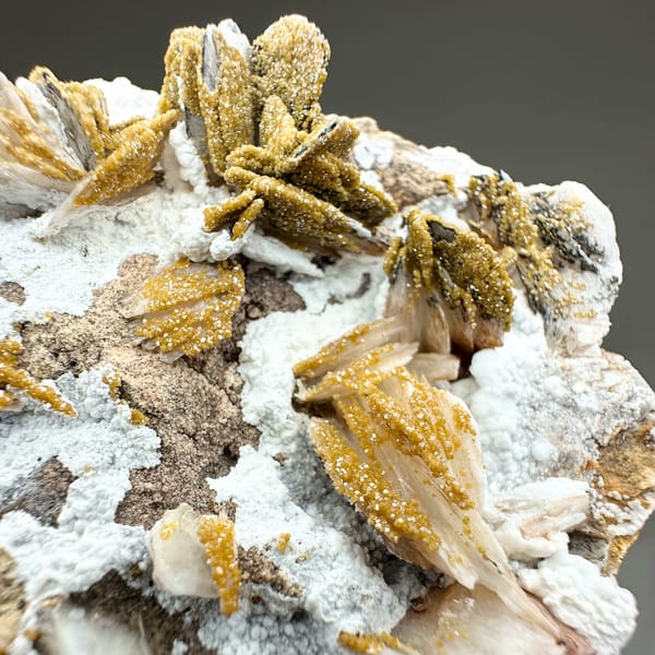 Golden baryte rosettes and white aragonite with mimetite from Morocco, top view