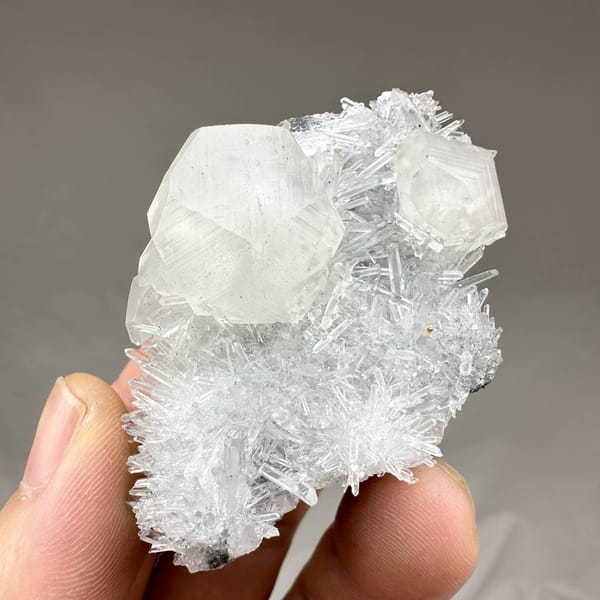 Large translucent calcite crystal in nest of quartz needles from Fujian, China, close-up of the crystal faces