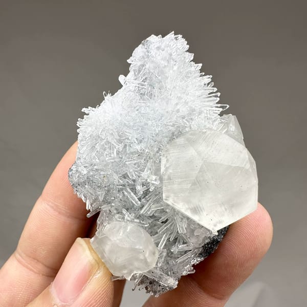 Large translucent calcite crystal in nest of quartz needles from Fujian, China, reverse side
