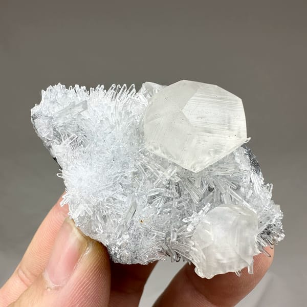 Large translucent calcite crystal in nest of quartz needles from Fujian, China, top view