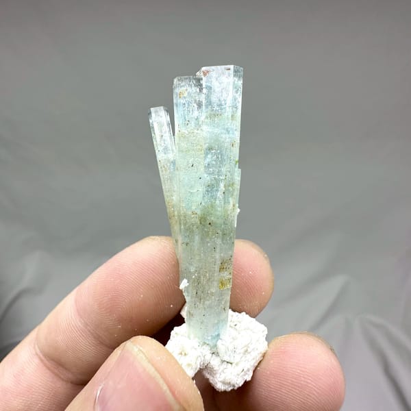 Sea-green aquamarine prism with white feldspar collar from Namibia, reverse side