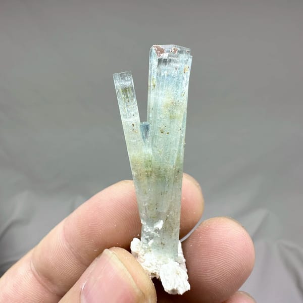 Sea-green aquamarine prism with white feldspar collar from Namibia, top view