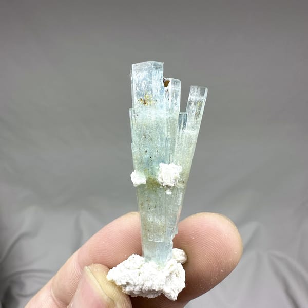 Sea-green aquamarine prism with white feldspar collar from Namibia, detail of the matrix contact
