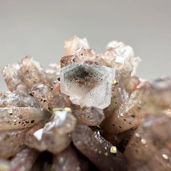 Red-brown hematoid quartz needles with pyrite and calcite from Fujian, China, close-up of the crystal faces