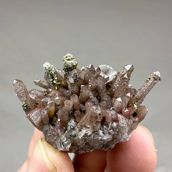 Red-brown hematoid quartz needles with pyrite and calcite from Fujian, China, top view