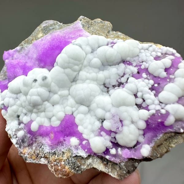 White aragonite balls in field of violet aragonite from Yunnan, China, second angle