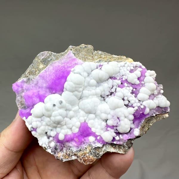 White aragonite balls in field of violet aragonite from Yunnan, China, reverse side