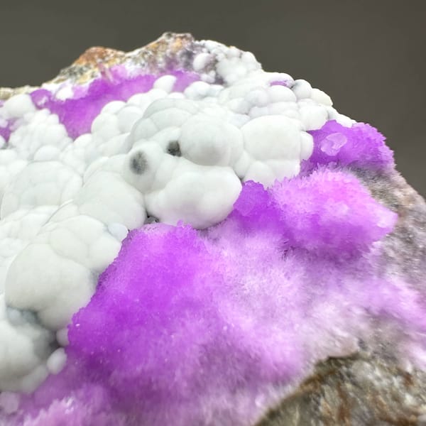 White aragonite balls in field of violet aragonite from Yunnan, China, top view