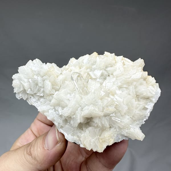 Plate of cream dolomite rhombs with clear quartz from Guizhou, China, detail of the matrix contact