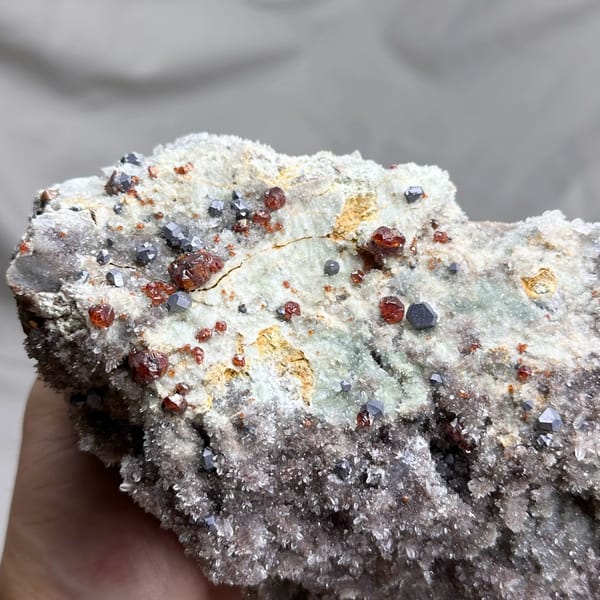 Large plate of red hematoid quartz with sphalerite and galena from Hunan, China, close-up of the crystal faces