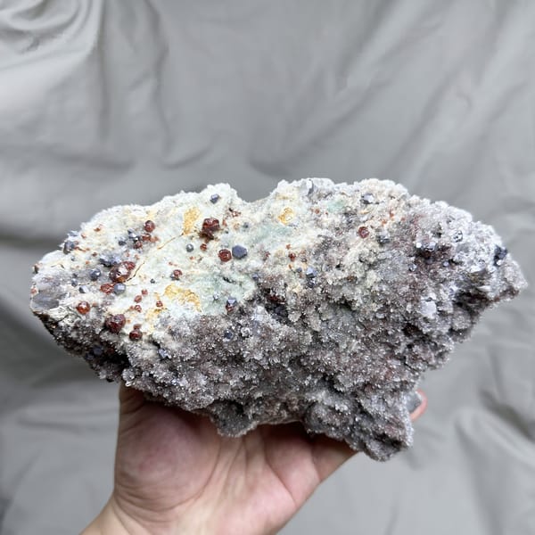 Large plate of red hematoid quartz with sphalerite and galena from Hunan, China, detail of the matrix contact