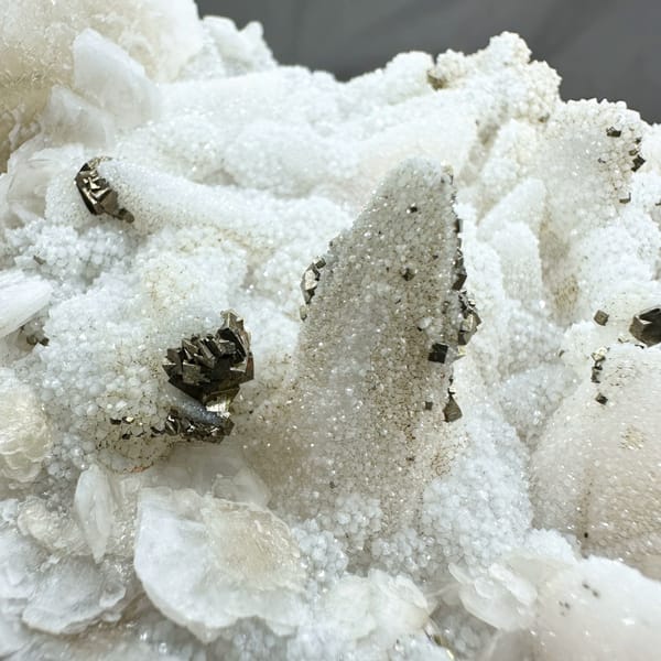 Plate of frosted white calcite crystals with pyrite from Fujian, China, reverse side