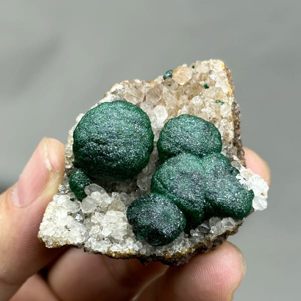 Three large velvet-green malachite balls on white quartz from DR Congo, reverse side