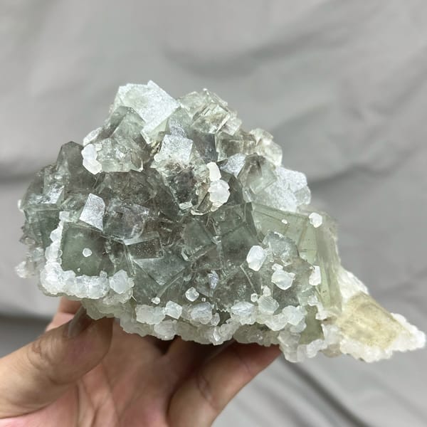Pale grey-green fluorite cubes with white calcite on plate from Xianghualing, Hunan, China, top view