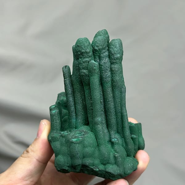 Dark green malachite stalactite pillars from DR Congo, close-up of the crystal faces