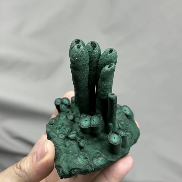 Dark green malachite stalactite pillars from DR Congo, detail of the matrix contact