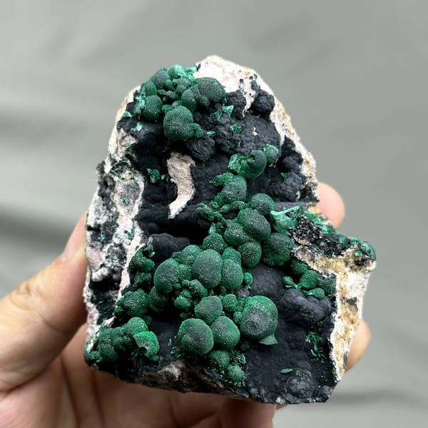 Green malachite balls over black manganese oxide from DR Congo, reverse side