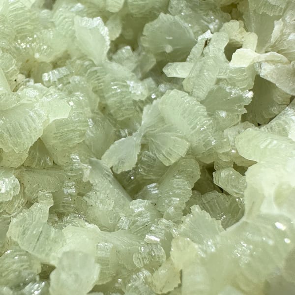 Pale green bow-tie prehnite plate with epidote from Morocco, top view