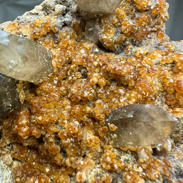 Smoky quartz points over Fanta-orange garnet druse from Yunxiao, Fujian, China, second angle