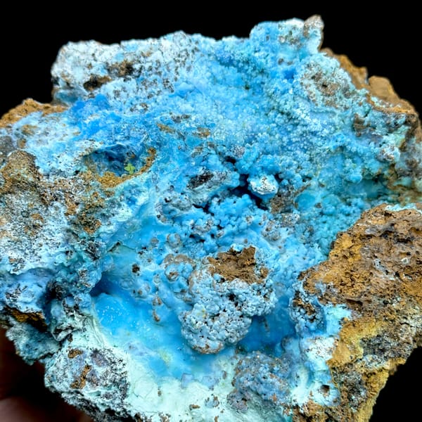 Electric-blue allophane crust in rusty rock pocket from Yunnan, China, top view