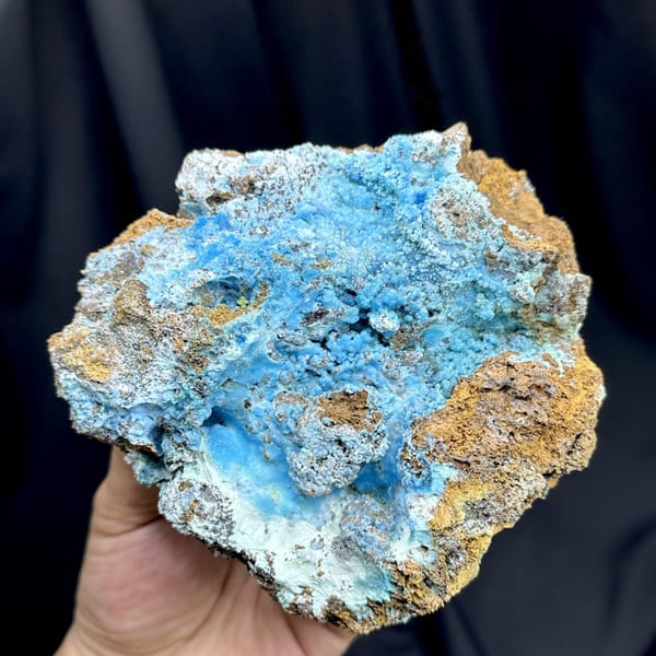 Electric-blue allophane crust in rusty rock pocket from Yunnan, China, detail of the matrix contact