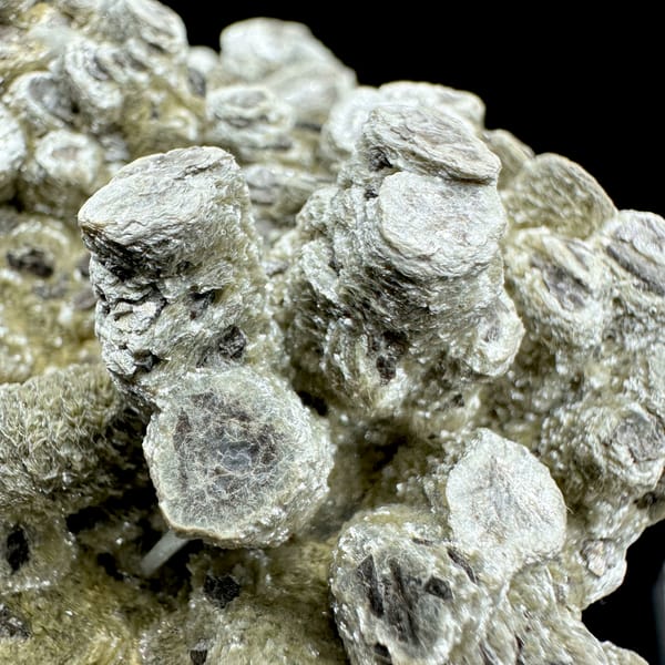 Stacked coin-like mica books covering a rounded mass from Inner Mongolia, China, second angle