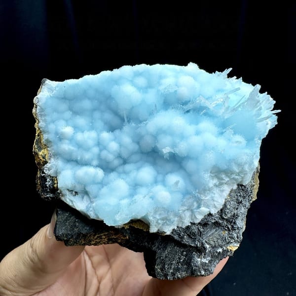 Dome of sky-blue acicular aragonite balls from Yunnan, China, detail of the matrix contact