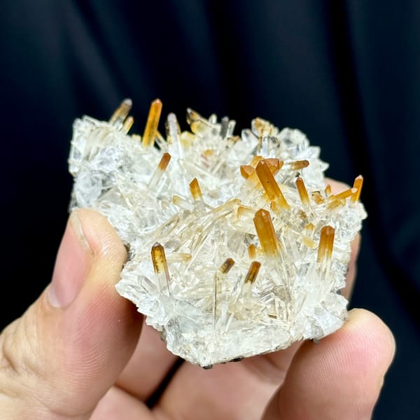 Clear quartz needles with mango-orange tips from Jinkouhe, Sichuan, China, close-up of the crystal faces