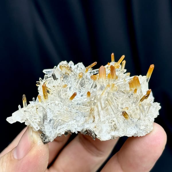 Clear quartz needles with mango-orange tips from Jinkouhe, Sichuan, China, top view