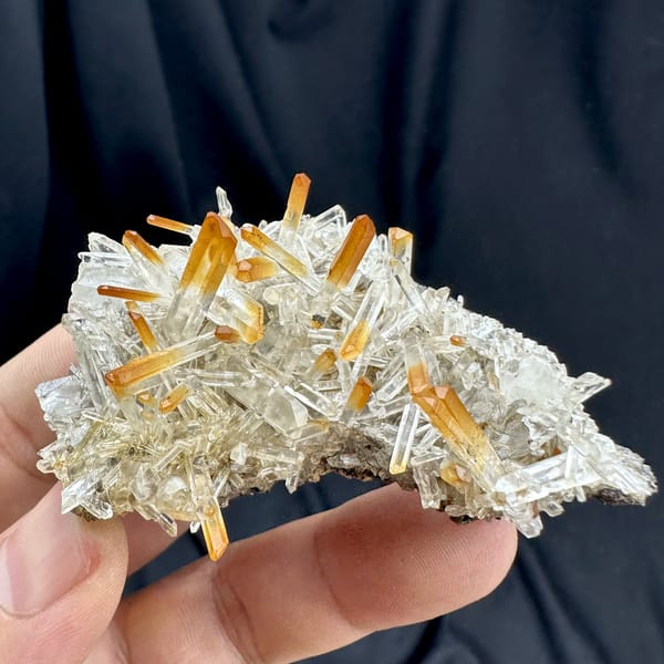 Orange-tipped clear quartz needle fan from Jinkouhe, Sichuan, China, top view