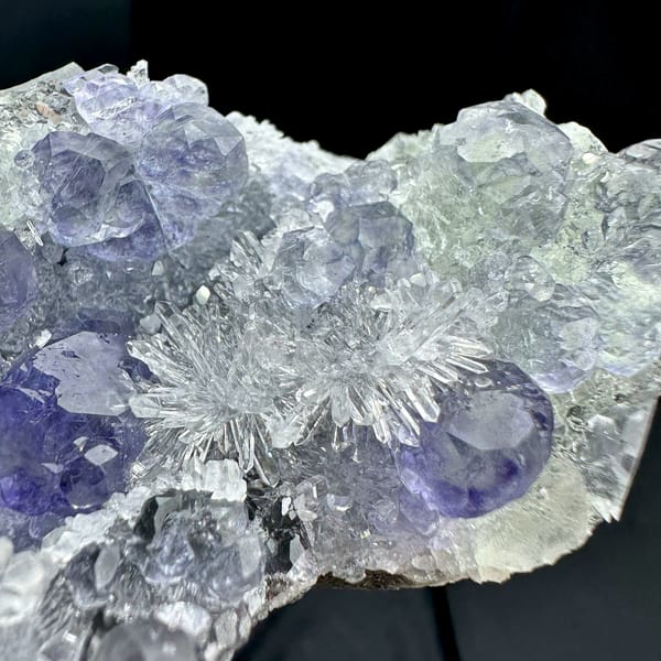 Long bar of sparkling quartz with violet-blue fluorite from Fujian, China, close-up of the crystal faces