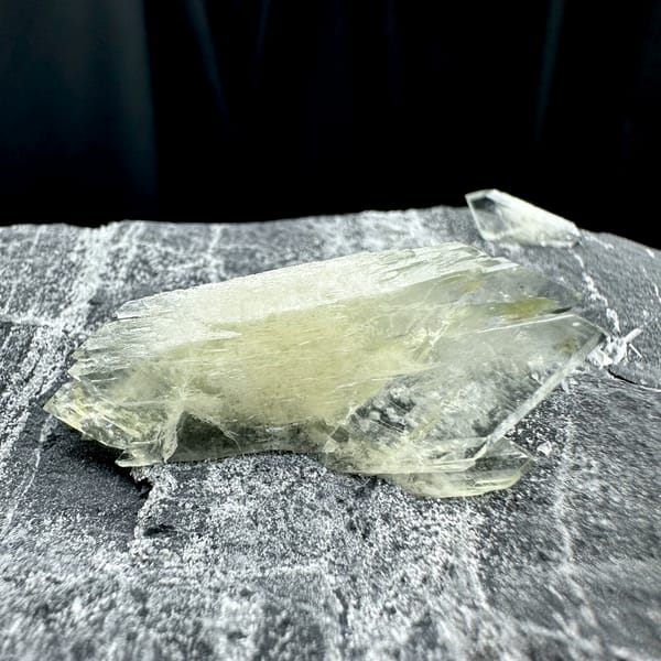 Large transparent double-terminated baryte blade on grey rock from Guangxi, China, close-up of the crystal faces