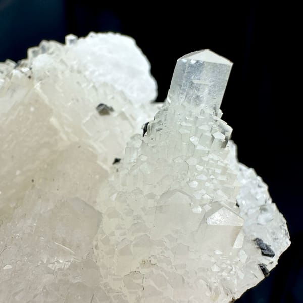 Transparent stepped tower calcite with black marmatite from Hunan, China, close-up of the crystal faces