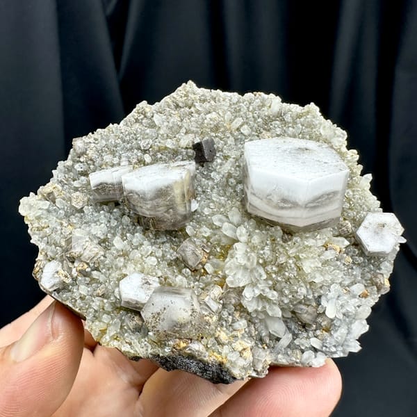 Hexagonal sandwich calcite plates with limonite on grey druse from Fujian, China, reverse side