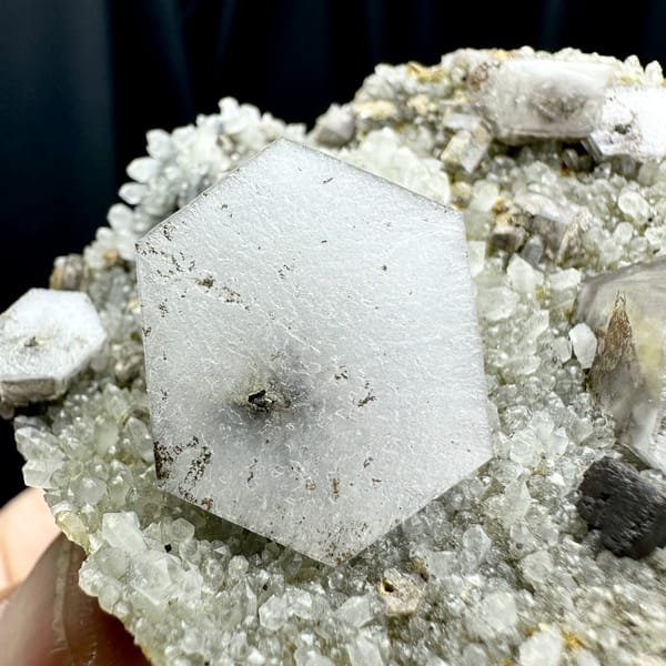 Hexagonal sandwich calcite plates with limonite on grey druse from Fujian, China, top view