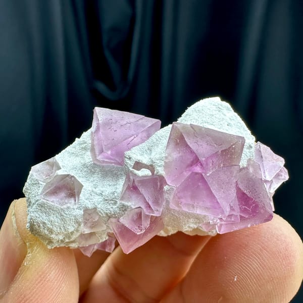Pink fluorite octahedra on white druse stalk from Zhejiang, China, second angle