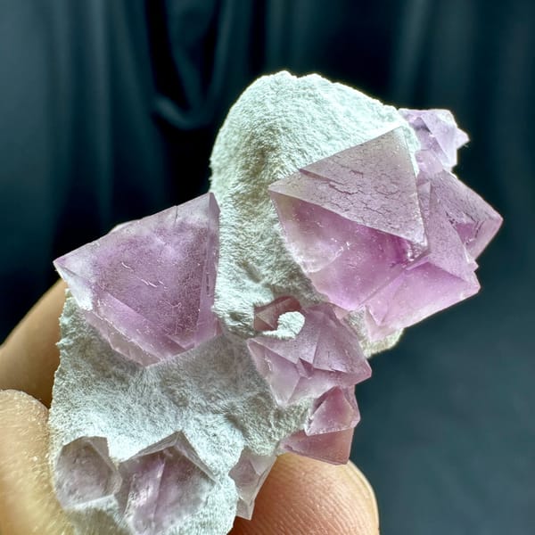Pink fluorite octahedra on white druse stalk from Zhejiang, China, top view