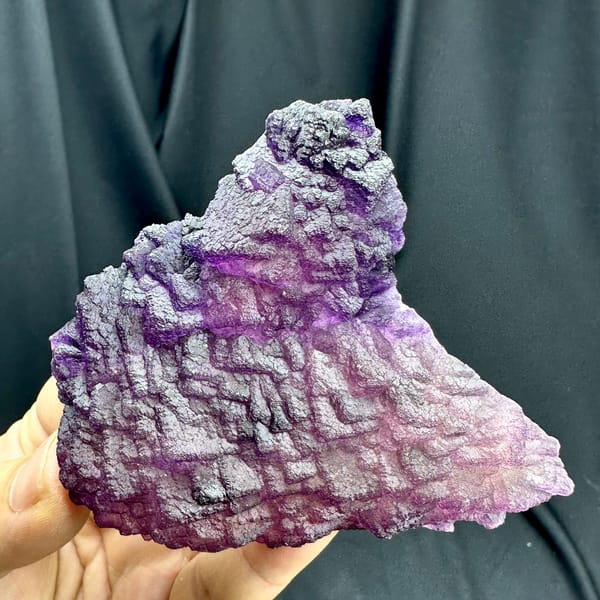 Magenta-purple stepped fluorite plate from Guizhou, China, close-up of the crystal faces