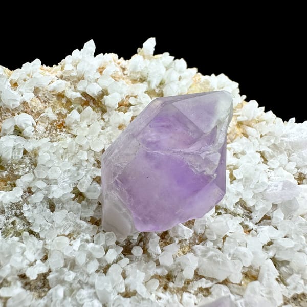 Pale amethyst point standing on white feldspar plate from Yunxiao, Fujian, China, reverse side