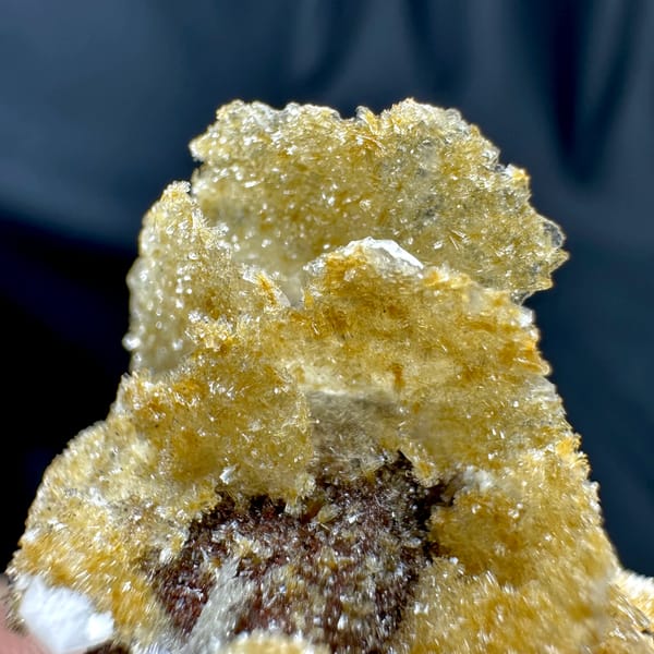 Golden layered wafer-biscuit calcite on dark matrix from Yunxiao, Fujian, China, top view